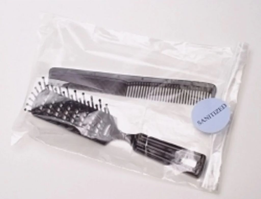 Plastic bag containing a disinfected hair brush.